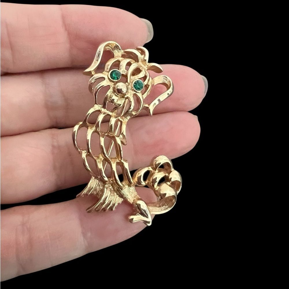 Vintage gold tone Avon dog brooch with green eyes stamped
